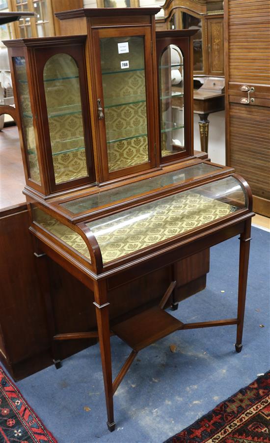 An Edwardian mahogany bijouterie cabinet, fitted plate glass shelves, raised on square tapered supports W.69cm.